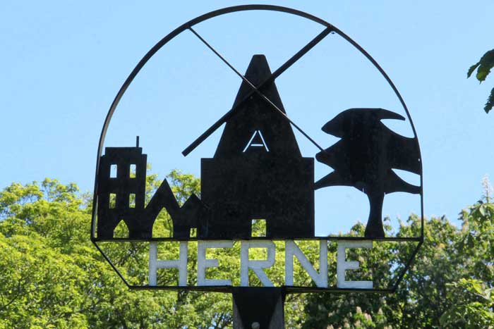 slide09 Herne sign with Herne Windmill, St. Martin's Church and a tree.